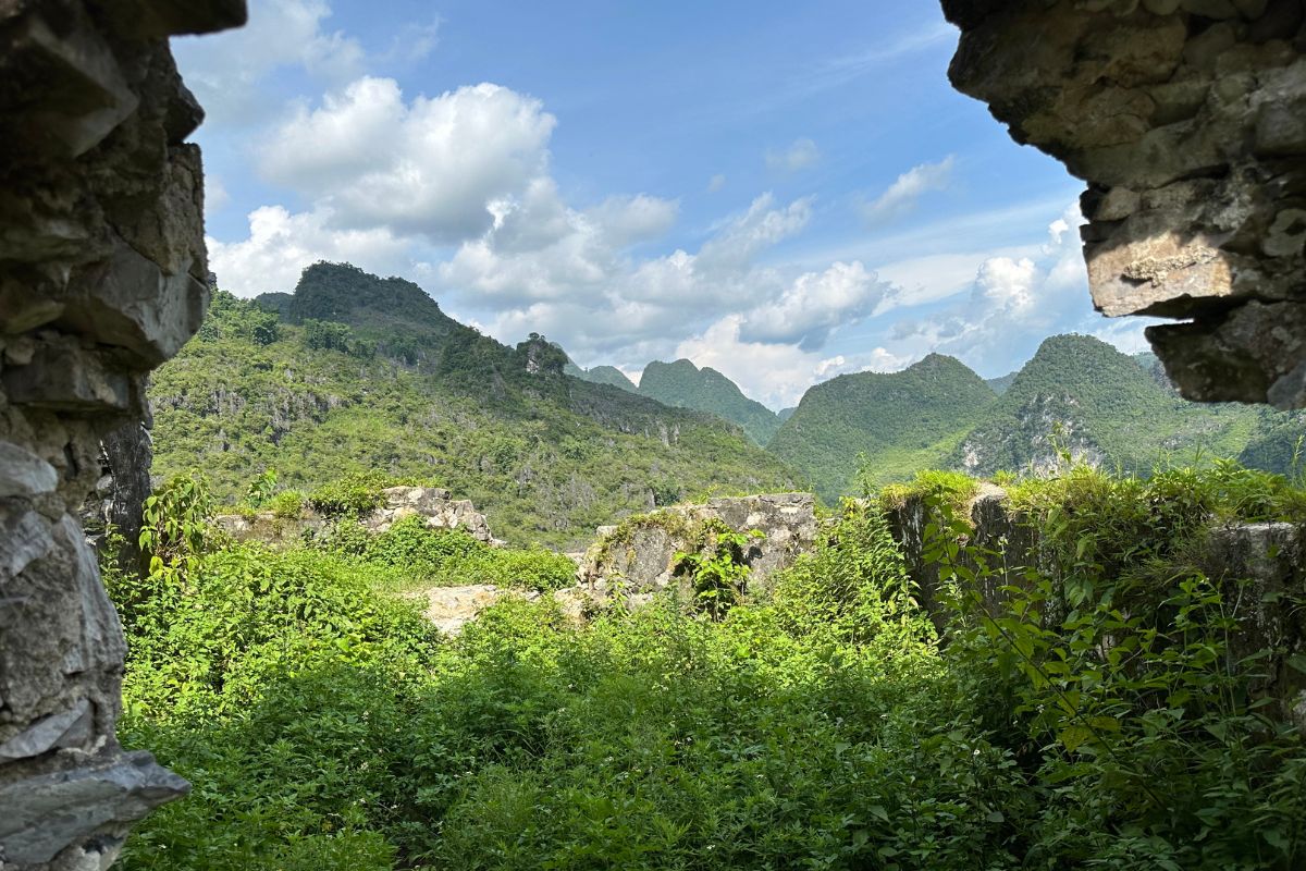 Mountain road flanked by the remnants of Lung Ho Wall, historically used to control movement.